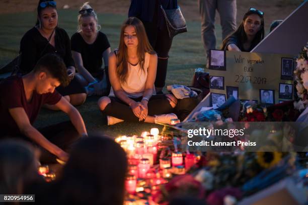 Mourners gather at a memorial to commemorate the victims of the shooting spree that one year ago left ten people dead, including the shooter, on July...