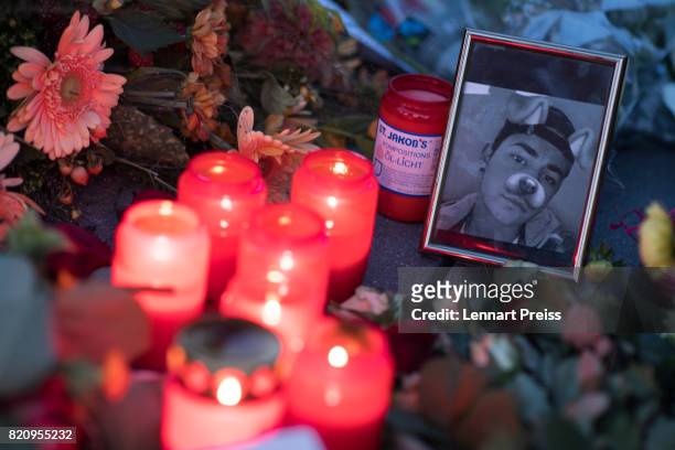 Candles and photographs are seen at a memorial to commemorate the victims of the shooting spree that one year ago left ten people dead, including the...