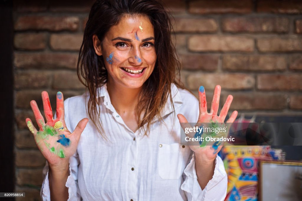 Joyful young painter woman