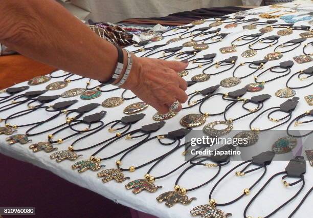 pendant imitation jewelry on sale at street stall - bijoutier stock-fotos und bilder