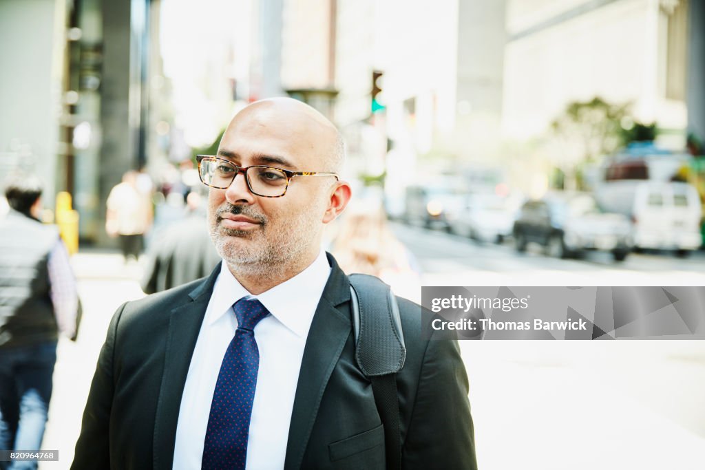 Businessman standing on city sidewalk