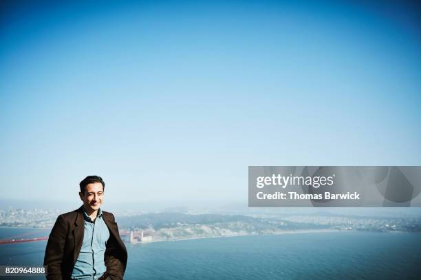 Smiling man standing at vista overlooking San Francisco