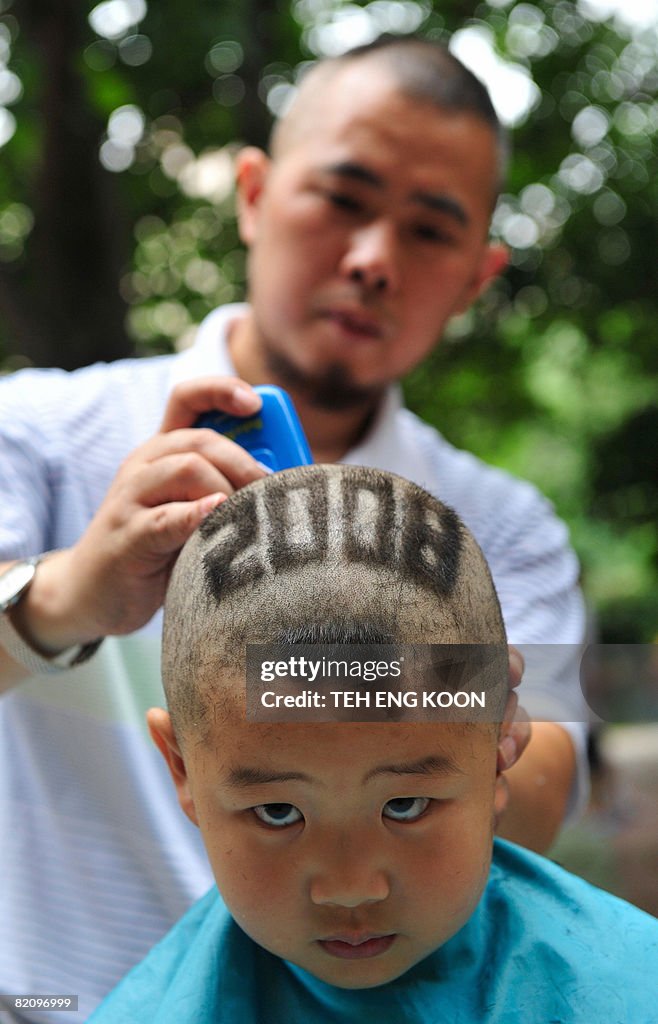 A young Chinese boy has hair cut with Beijing Olympic Games emblem... News Photo - Getty Images A young Chinese boy has hair cut with Beijing Olympic Games emblem... News Photo - Getty Images