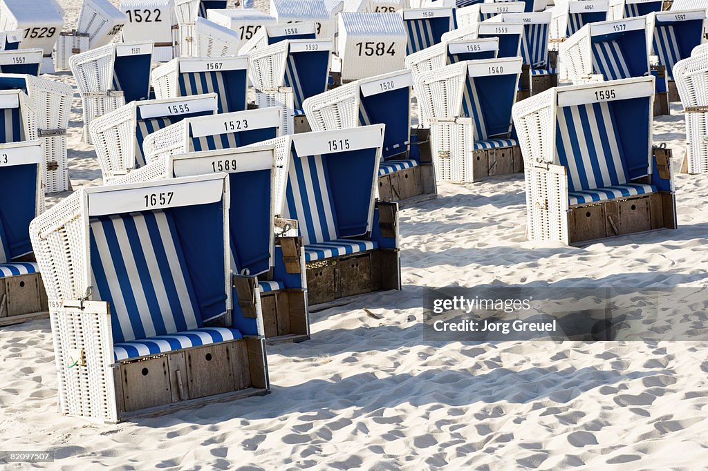 Wicker beach chairs on beach 