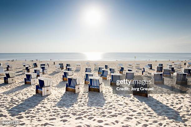 wicker chairs on beach  - hooded beach chair stock pictures, royalty-free photos & images