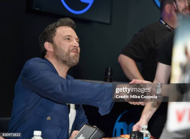 Actor Ben Affleck greets a fan during the "Justice League" autograph signing at Comic-Con International 2017 at San Diego Convention Center on July...