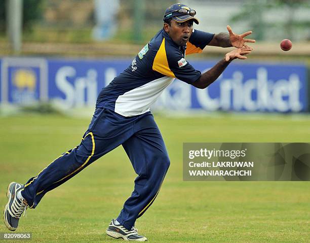 Sri Lankan cricket captain Mahela Jayawardene catches a ball during a practice session at The Galle International Cricket Stadium in Galle on July...