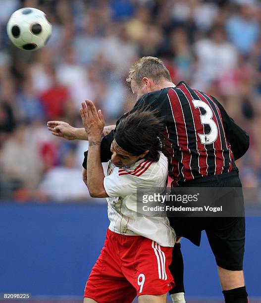 Paolo Guerrero of Hamburg challenges Michael Ball of Manchester City for the ball during a pre season friendly match between Hamburger SV and...