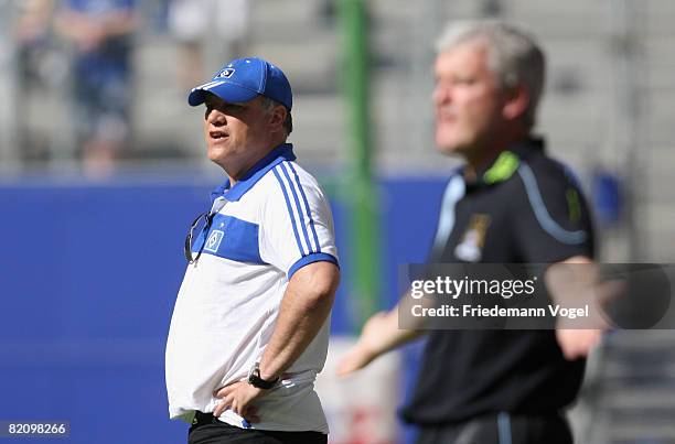 Coach Martin Jol of Hamburg and Coach Mark Hughes of Manchester City look on during a pre season friendly match between Hamburger SV and Manchester...