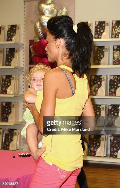 Katie Price holds Princess Tiaami during the launch of her bed linen range at Matalan on July 29, 2008 in Milton Keynes, England.