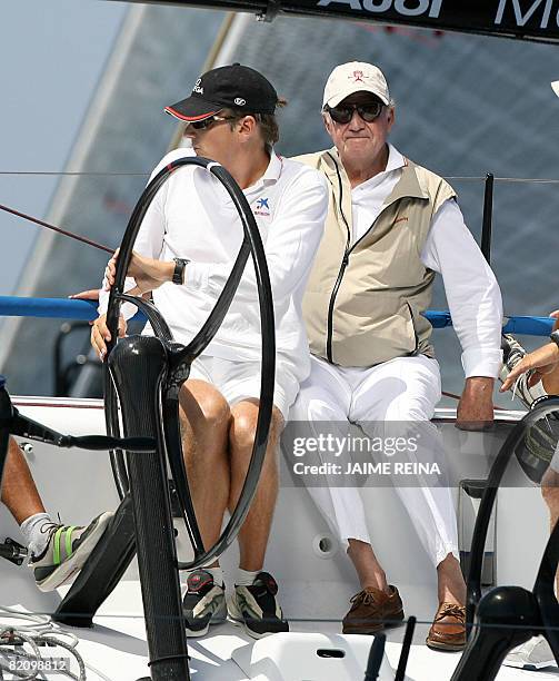 Spain's King Juan Carlos sits on Bribon next to New Zealand skipper Dean Parker during the second day of racing in the Copa del Rey regatta off the...