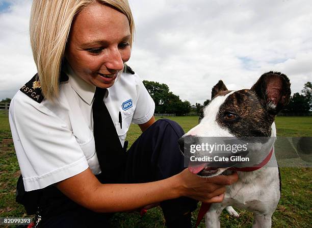 Inspector Bartle takes Saffron for a walk at the Southridge Animal Centre on July 29, 2008 in London, England. Saffron had her ears cut off by her...