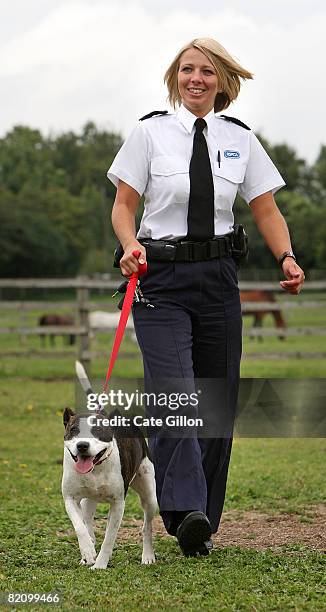 Inspector Bartle takes Saffron for a walk at the Southridge Animal Centre on July 29, 2008 in London, England. Saffron had her ears cut off by her...