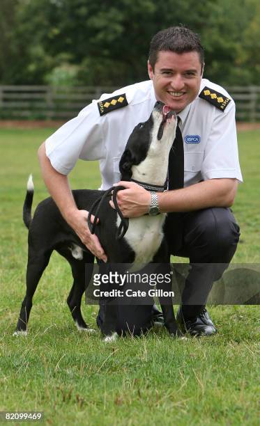 Inspector Simon Osborne takes collie cross-bred dog, 'Warrier' for a walk at the Southridge Animal Centre on July 29, 2008 in London, England....