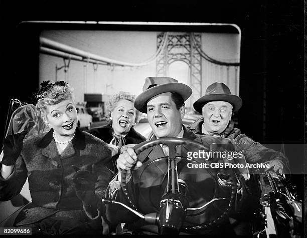 The cast of 'I Love Lucy' sits in a convertible with a backdrop of a suspension bridge behind them in an episode titled 'California, Here We Come!'...