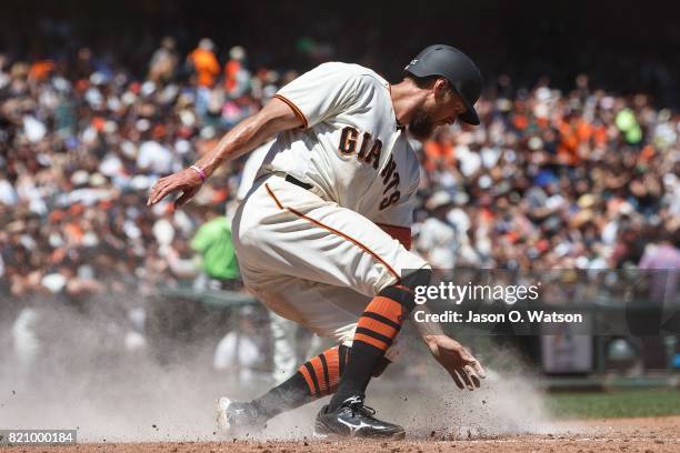 Hunter Pence of the San Francisco Giants slides into home plate to score a run against the San Diego Padres during the fourth inning at AT&T Park on...