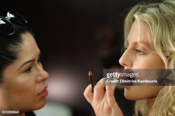 Model prepares backstage at SWIMMIAMI Gottex Cruise 2018 Fashion Show at WET Deck at W South Beach on July 22, 2017 in Miami Beach, Florida.