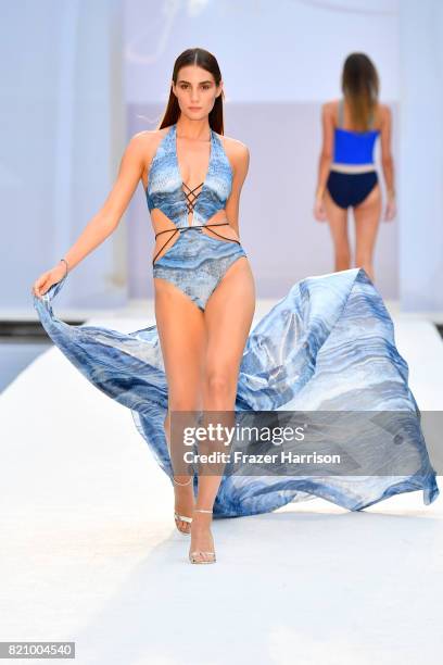 Model walks the runway at SWIMMIAMI Gottex Cruise 2018 Fashion Show at WET Deck at W South Beach on July 22, 2017 in Miami Beach, Florida.