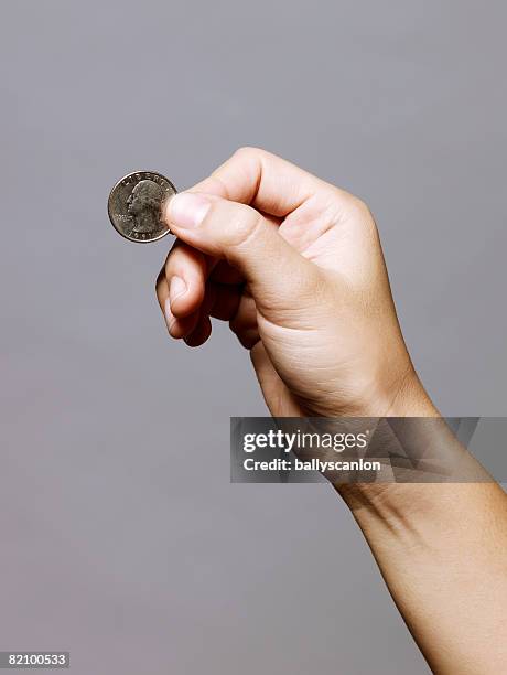 hand holding a quarter (25 cents) - 25 cents stock pictures, royalty-free photos & images