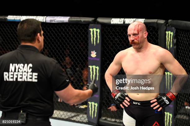 Patrick Cummins listens to referee John McCarthy between a stoppage against Gian Villante in their light heavyweight bout during the UFC Fight Night...