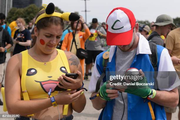 Attendees in Pokemon cosplay attend the Pokemon GO Fest at Grant Park on July 22, 2017 in Chicago, Illinois.