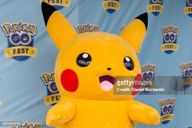 Costumed Pikachu character poses with attendees during the Pokemon GO Fest at Grant Park on July 22, 2017 in Chicago, Illinois.