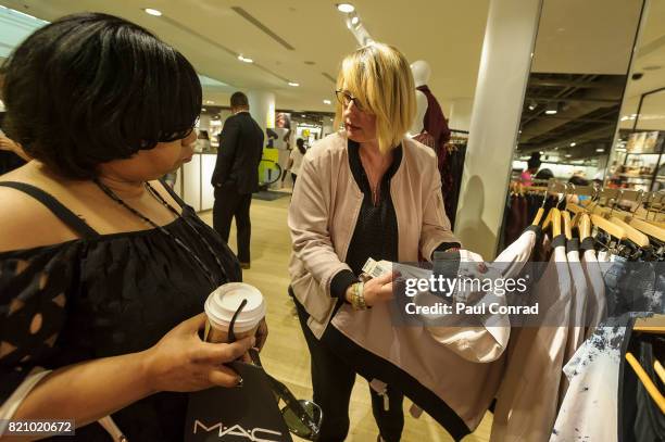 Shoppers examine Rebel Wilson X Angels Collection signature Bomber Jacket at Nordstrom Downtown Seattle on July 22, 2017 in Seattle, Washington....
