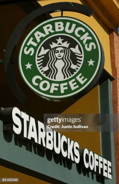 Signs are seen in the front of a Starbucks coffee shop January 22, 2004 in San Francisco, California. In an effort to cut costs, the coffee chain...