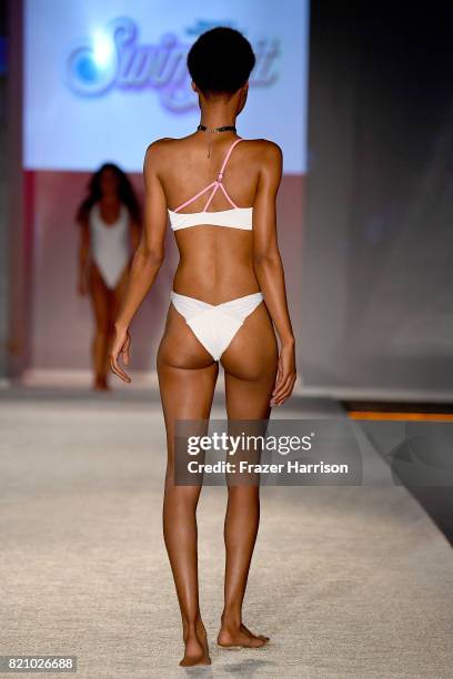 Model walks the runway during SWIMMIAMI Sports Illustrated Swimsuit 2018 Collection at WET Deck at W South Beach on July 22, 2017 in Miami Beach,...