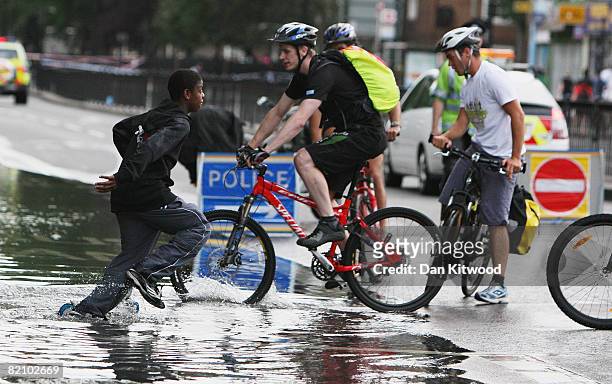Burst water main causes chaos for evening commuters on July 30, 2008 in London, England. The burst main meant police and fire crews had to close off...
