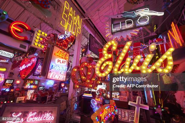 An array of neon lights and signs are displayed inside God's Own Junkyard gallery, cafe and workshop in Walthamstow, east London on July 8, 2017....