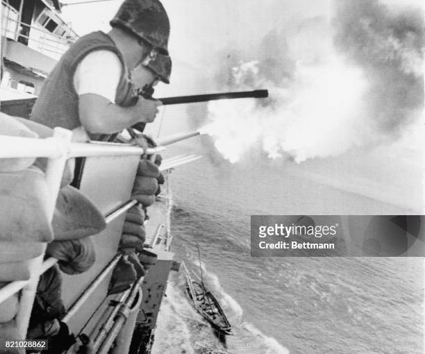 North Vietnamese fishing boat brushes past the cruiser U.S.S. Newport as she fires her eight-inch guns at Than Hoa.