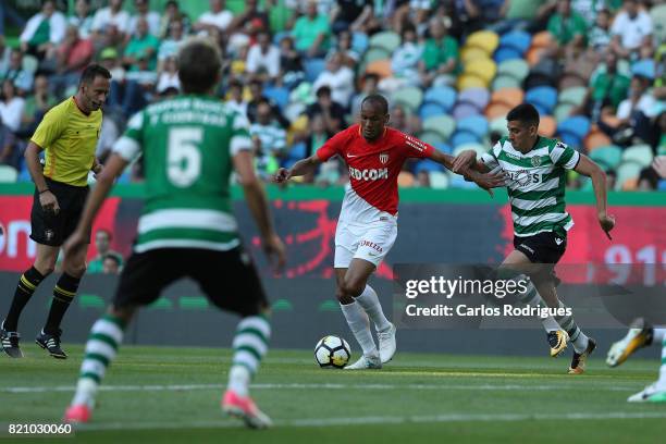 Monaco midfielder Fabinho from Brasil tries to escape Sporting CP midfielder Rodrigo Battaglia from Argentina during the Friendly match between...