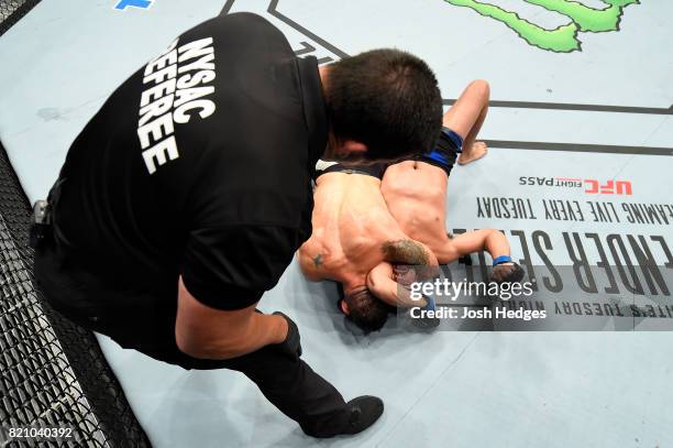 Chris Weidman attempts to submit Kelvin Gastelum in their middleweight bout during the UFC Fight Night event inside the Nassau Veterans Memorial...