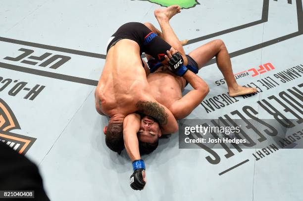 Chris Weidman attempts to submit Kelvin Gastelum in their middleweight bout during the UFC Fight Night event inside the Nassau Veterans Memorial...
