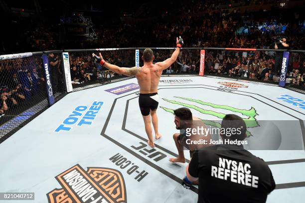 Chris Weidman celebrates after submitting Kelvin Gastelum in their middleweight bout during the UFC Fight Night event inside the Nassau Veterans...