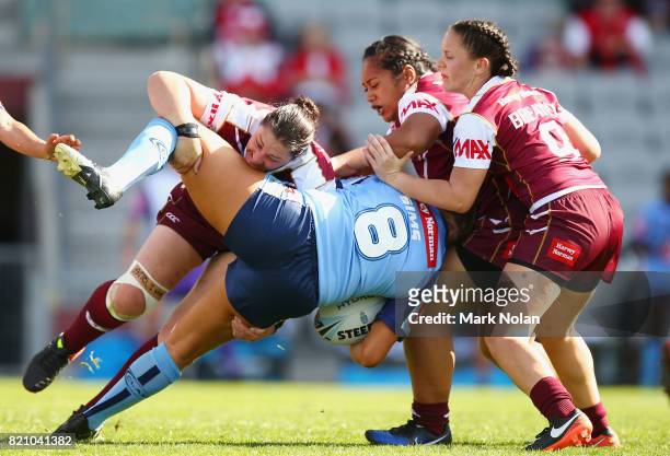 Stephanie Hancock of Queensland tackles Ruan Sims of NSW during the Women's Interstate Challenge match between New South Wales and Queensland at WIN...