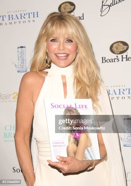 Cover star Christie Brinkley holds Social Life Magazine at the 6th Annual St. Barth Hamptons Gala at the Bridgehampton Historical Museum on July 22,...