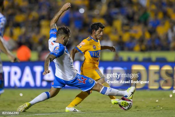 Damian Alvarez of Tigres fights for the ball with Pablo Miguez of Puebla during the 1st round match between Tigres UANL and Puebla as part of the...