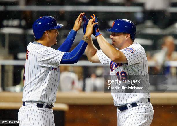 Jay Bruce of the New York Mets follows celebrates his sixth inning two run home run against the Oakland Athletics with teammate Wilmer Flores at Citi...
