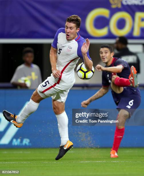 Kenner Gutierrez of Costa Rica deflects a kist by Kelyn Rowe of United States during the 2017 CONCACAF Gold Cup Semifinal at AT&T Stadium on July 22,...