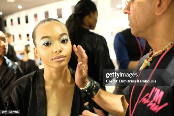 Model prepares backstage at the SWIMMIAMI Minimale Animale 2018 Collection fashion show at Ora Nightclub on July 22, 2017 in Miami Beach, Florida.