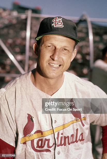 Outfielder/First Baseman Stan Musial of the St. Louis Cardinals leans on his bat in front of the batting cage before an early circa 1960's Major...