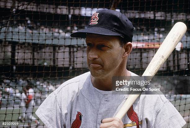 Outfielder/First Baseman Stan Musial of the St. Louis Cardinals with bat on shoulder infront of the batting cage before an early circa 1960's Major...
