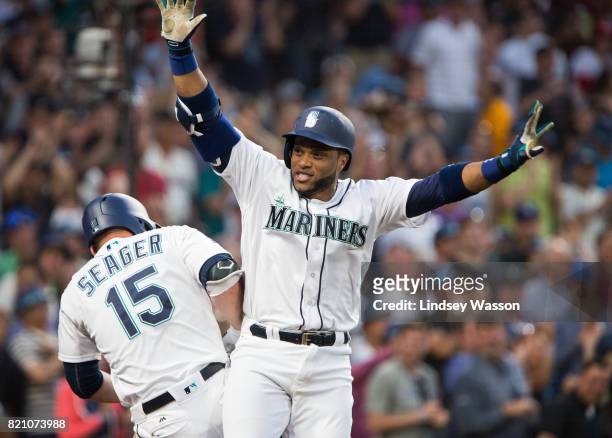 Robinson Cano of the Seattle Mariners celebrates his home run with Kyle Seager to put the Mariners ahead in the eighth inning against the New York...