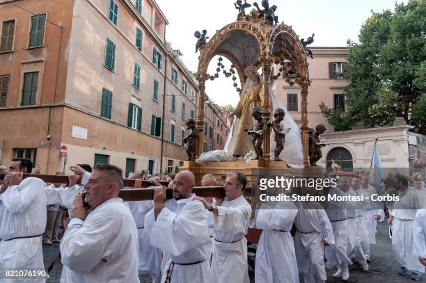 The bearers carry the statue for the Solemn celebrations and procession in honor of Madonna del Carmine, Our Lady of Roman Citizens, called 'de...