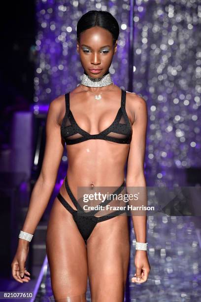 Model walks the runway at the SWIMMIAMI Minimale Animale 2018 Collection fashion show at Ora Nightclub on July 22, 2017 in Miami Beach, Florida.