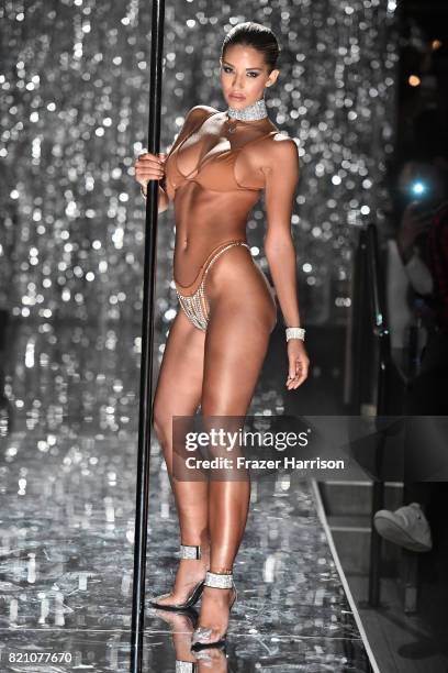 Model walks the runway at the SWIMMIAMI Minimale Animale 2018 Collection fashion show at Ora Nightclub on July 22, 2017 in Miami Beach, Florida.