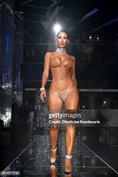 Model walks the runway at the SWIMMIAMI Minimale Animale 2018 Collection fashion show at Ora Nightclub on July 22, 2017 in Miami Beach, Florida.