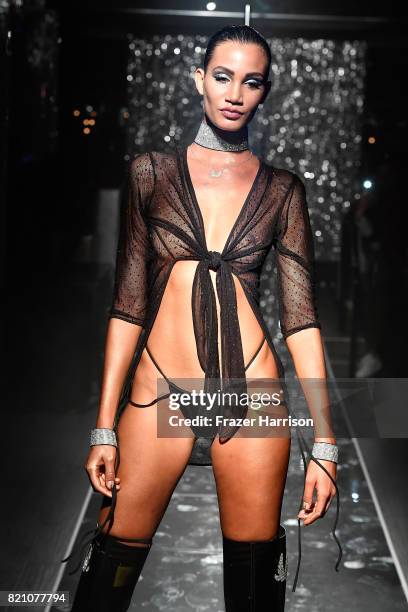 Model walks the runway at the SWIMMIAMI Minimale Animale 2018 Collection fashion show at Ora Nightclub on July 22, 2017 in Miami Beach, Florida.